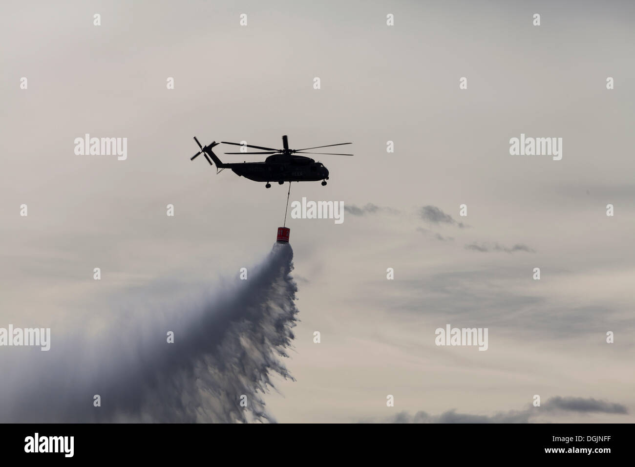 CH53 helicopter carrying a water tank during an exercise, dropping