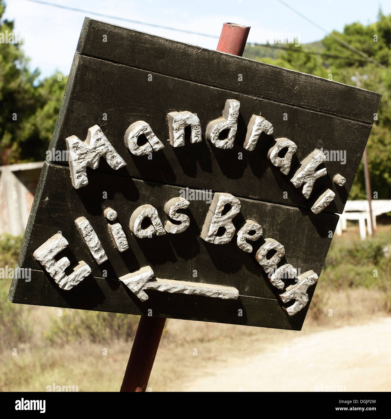 A tourist sign showing the direction to Mandraki Elias Beach on the Greek Island of Skiathos in the Aegean Sea. Stock Photo