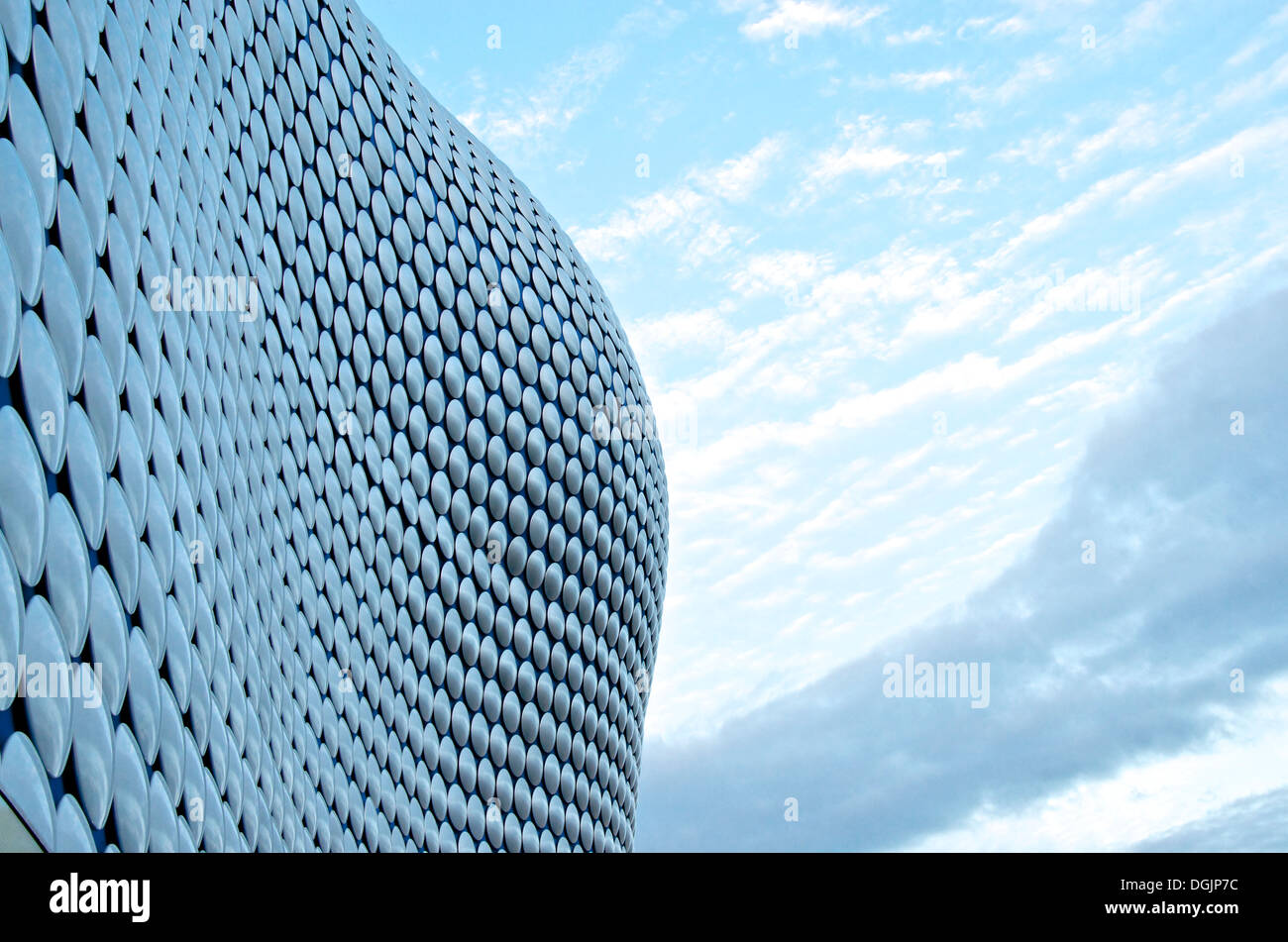 Outline of Selfridges building in Birmingham, UK against blue sky and trailing clouds. Stock Photo