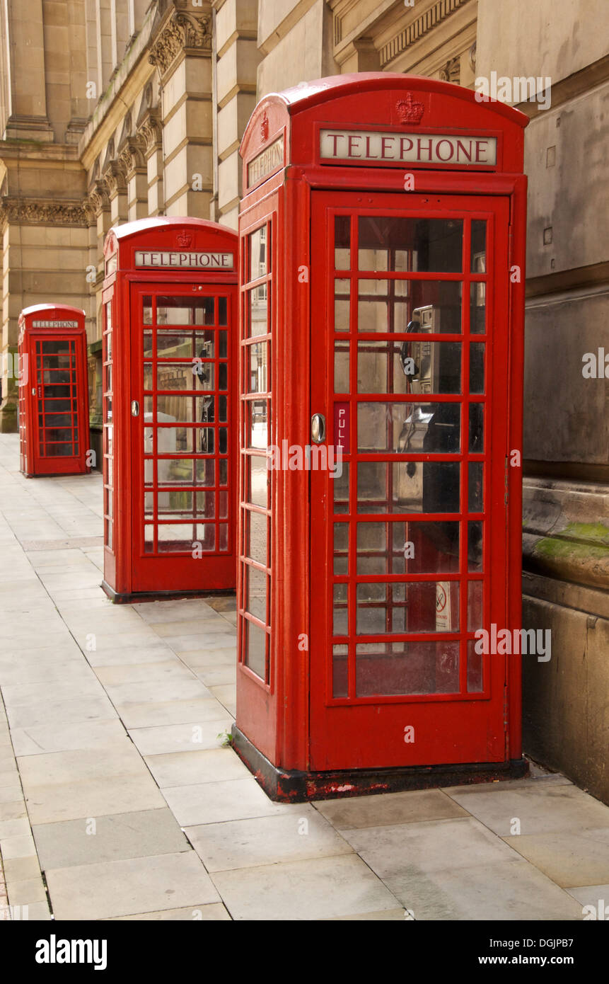 Three old style K6 red telephone boxes in Eden Place Birmingham UK Stock Photo