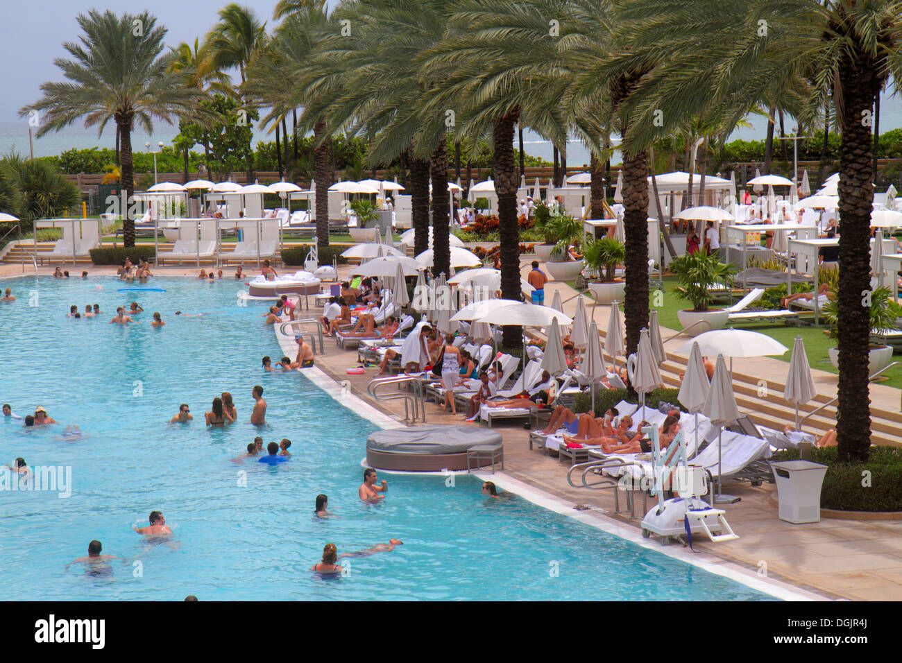 Miami Beach Florida,Collins Avenue,Fontainebleau,Miami Beach,hotel,swimming pool area,guests,sunbathers,looking FL130731194 Stock Photo