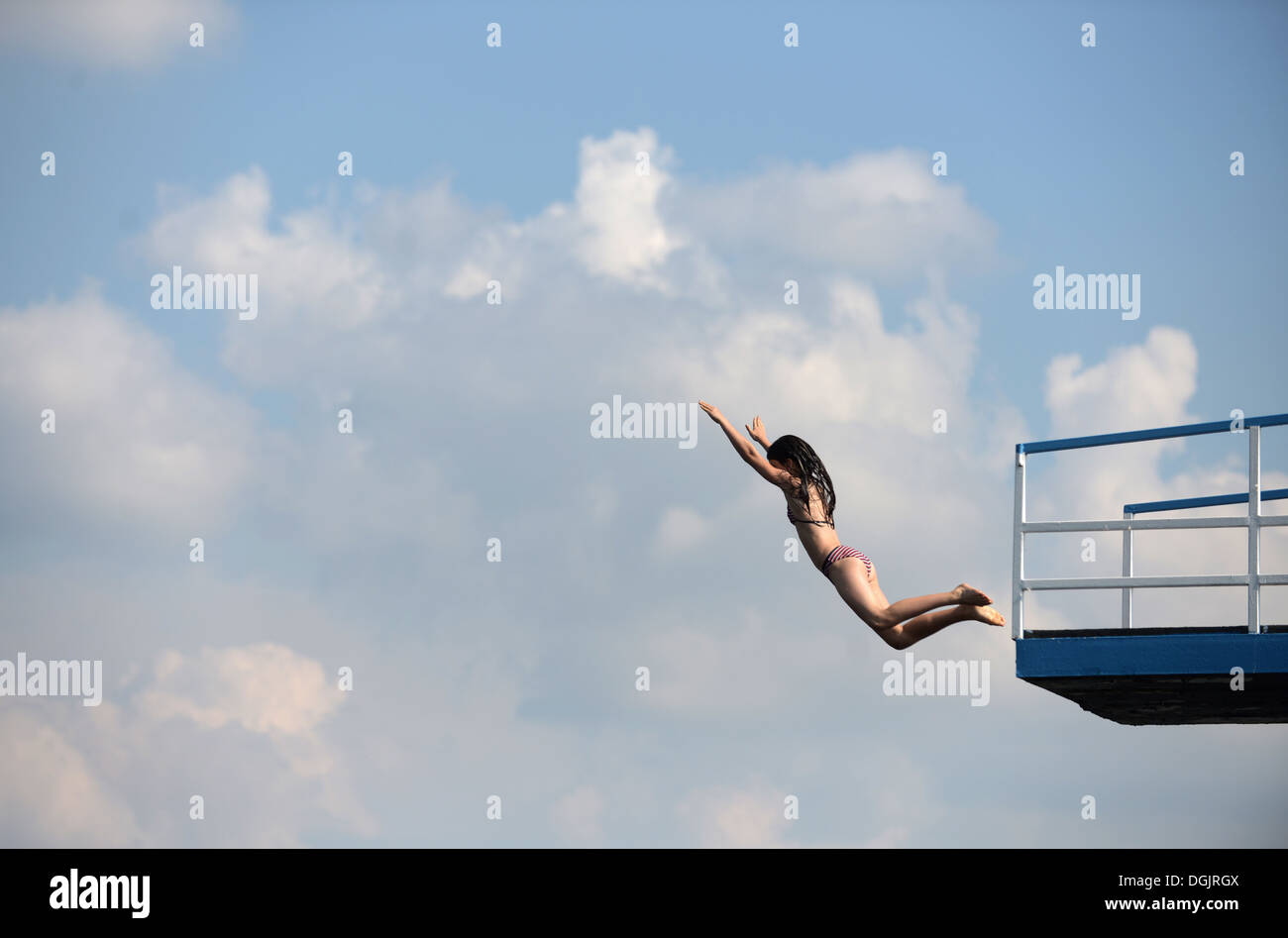 Berlin, Germany, a girl jumps from the diving tower in the seaside