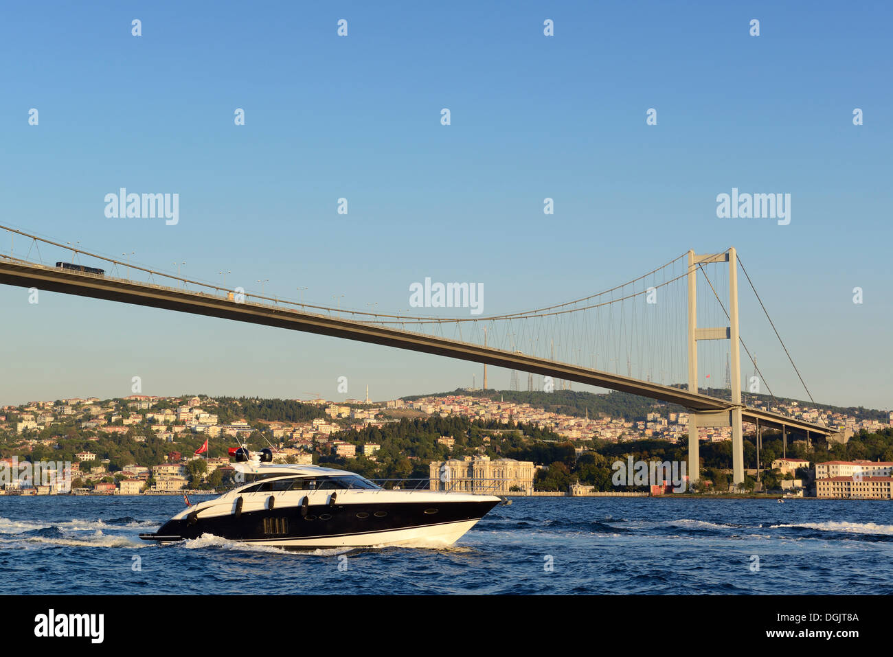 Motor yacht on the Bosphorus, Bosphorus Bridge and Beylerbeyi Palace on the Asian shore, seen from Ortakoey, Istanbul Stock Photo