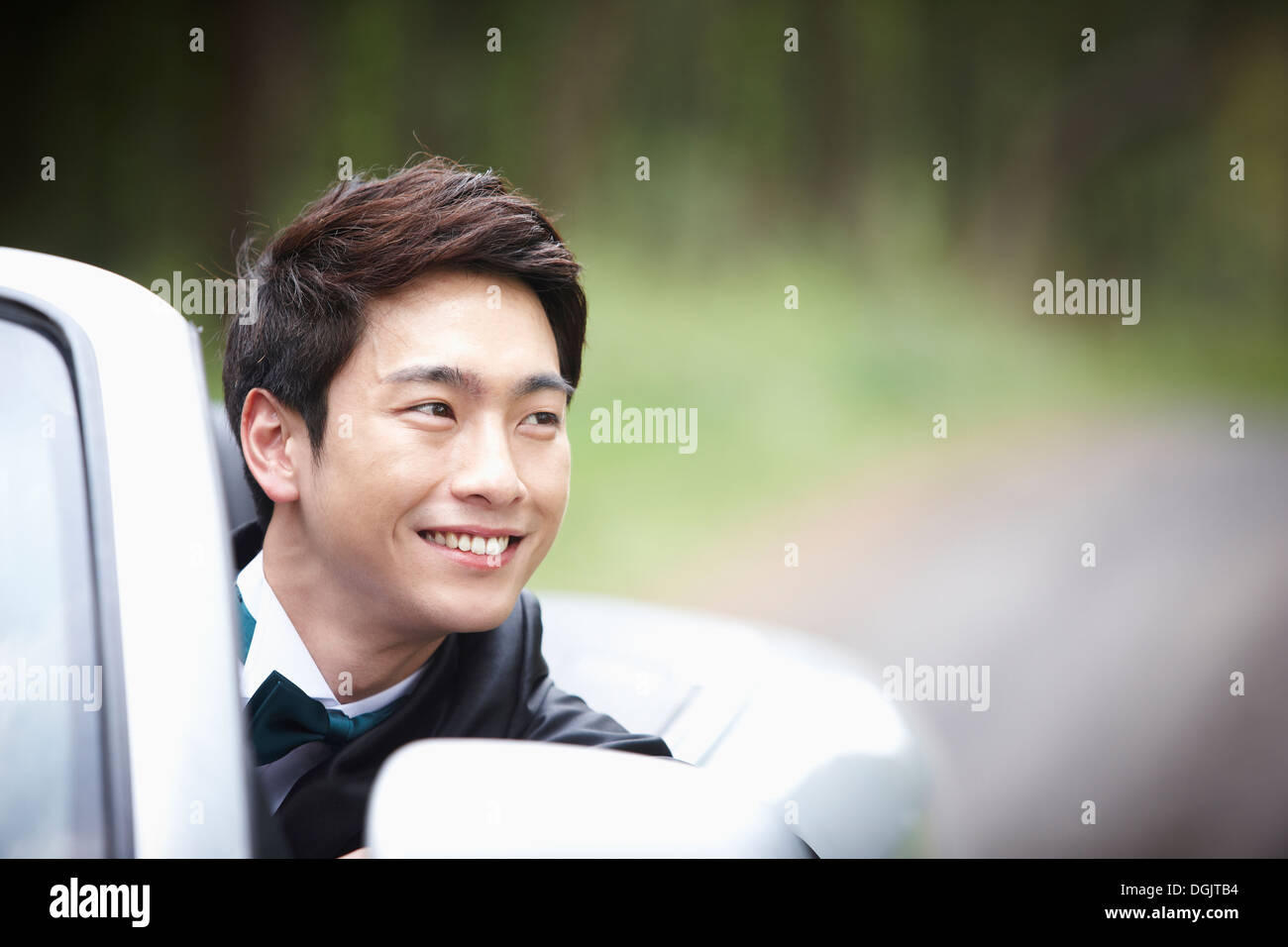 a groom sitting in a convertible car Stock Photo - Alamy