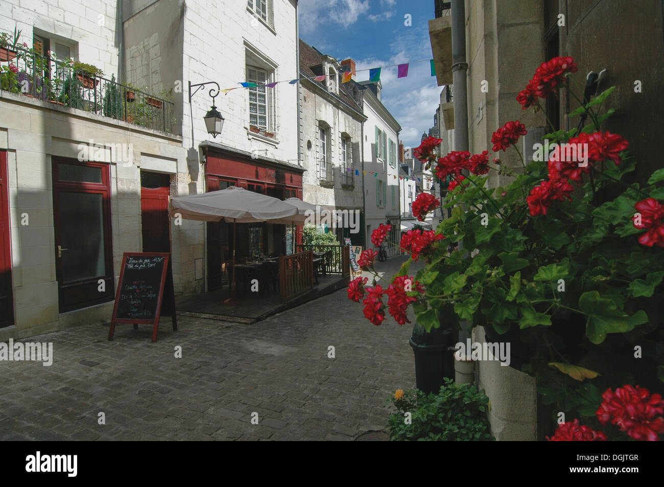 cobbled street in loches france with cafe and flowers Stock Photo