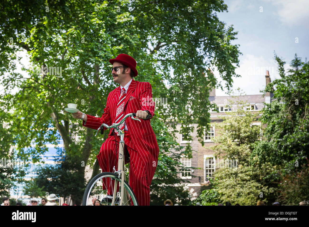 A contestant participating in the Passing of the teacup event in the 2013 Chap Olympiad held in Bedford Square Gardens. Stock Photo
