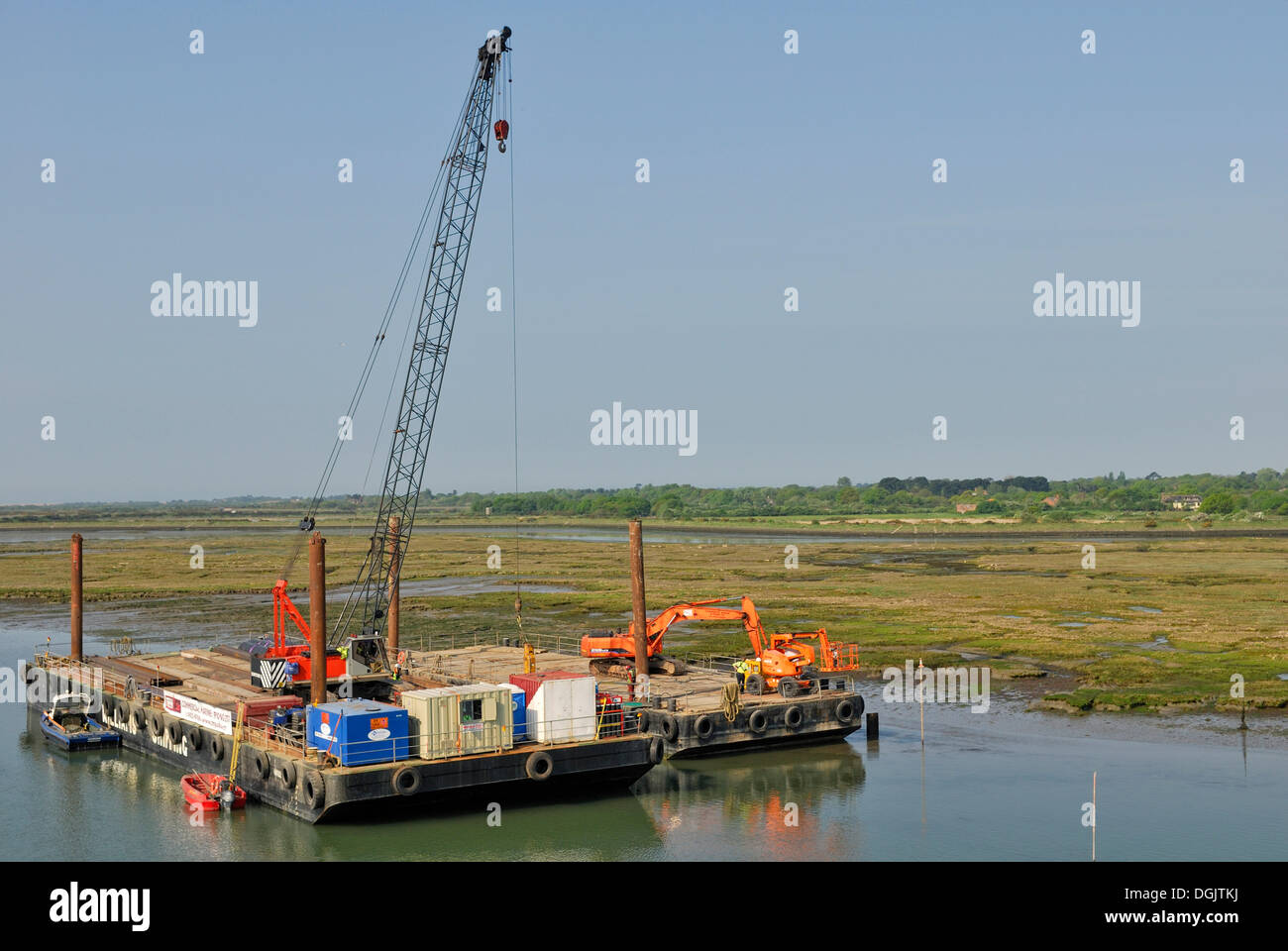 Harbour construction site with cranes and excavators on pontoons