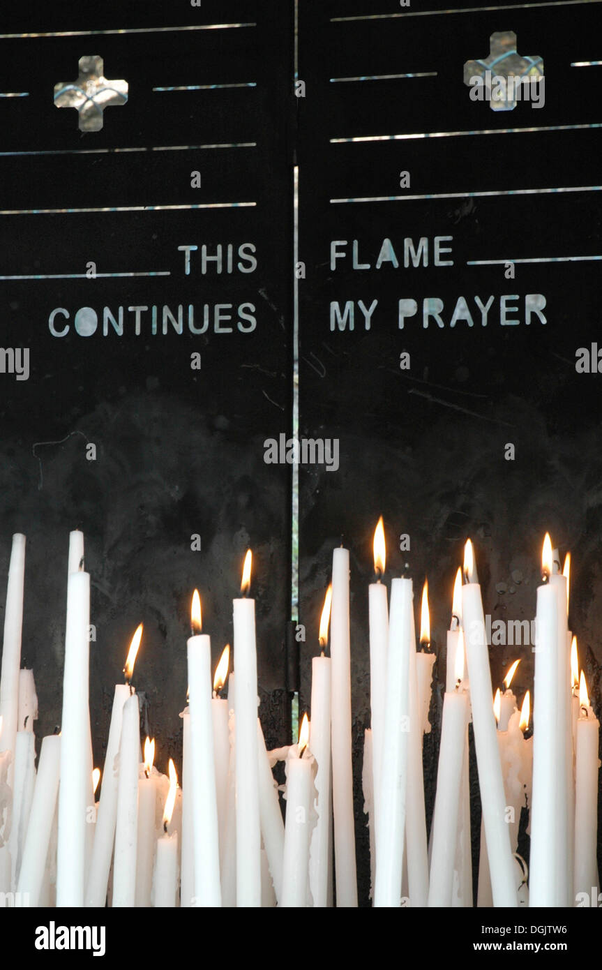 prayer candles at the grotto of our lady of lourdes church in france