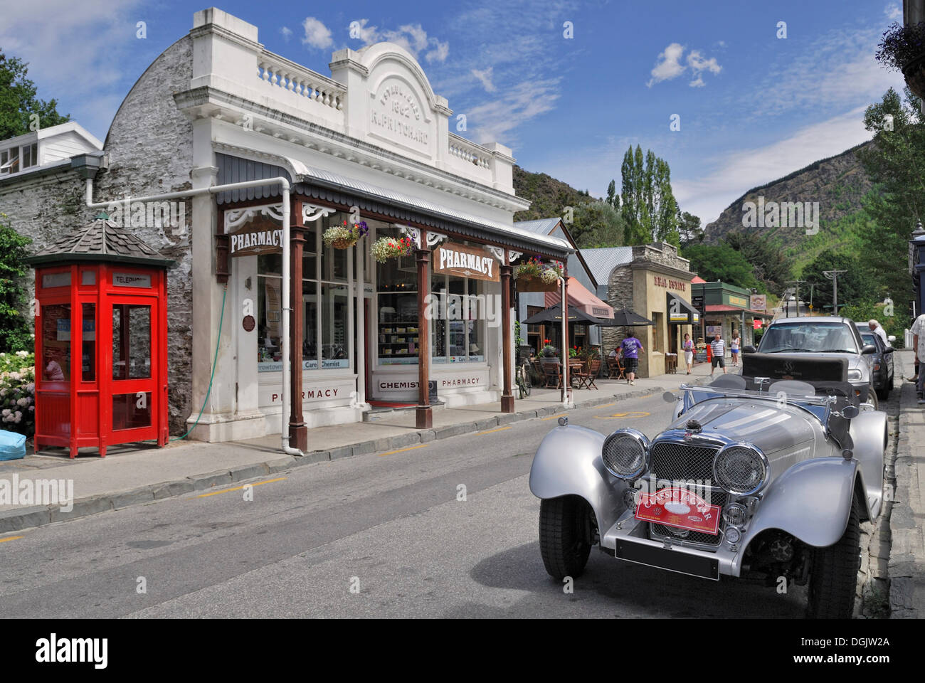 Historic buildings, pharmacy, Jaguar vintage car, gold rush town Arrowtown, South Island, New Zealand Stock Photo