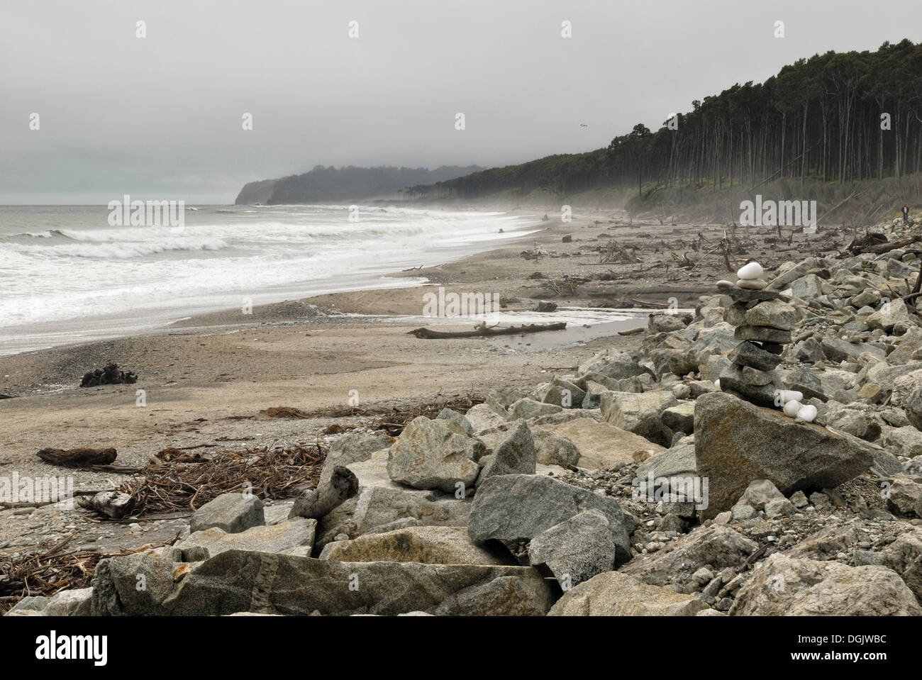 Bruce Bay with a cairn in bad weather, Tasman Sea, South Island, New Zealand Stock Photo