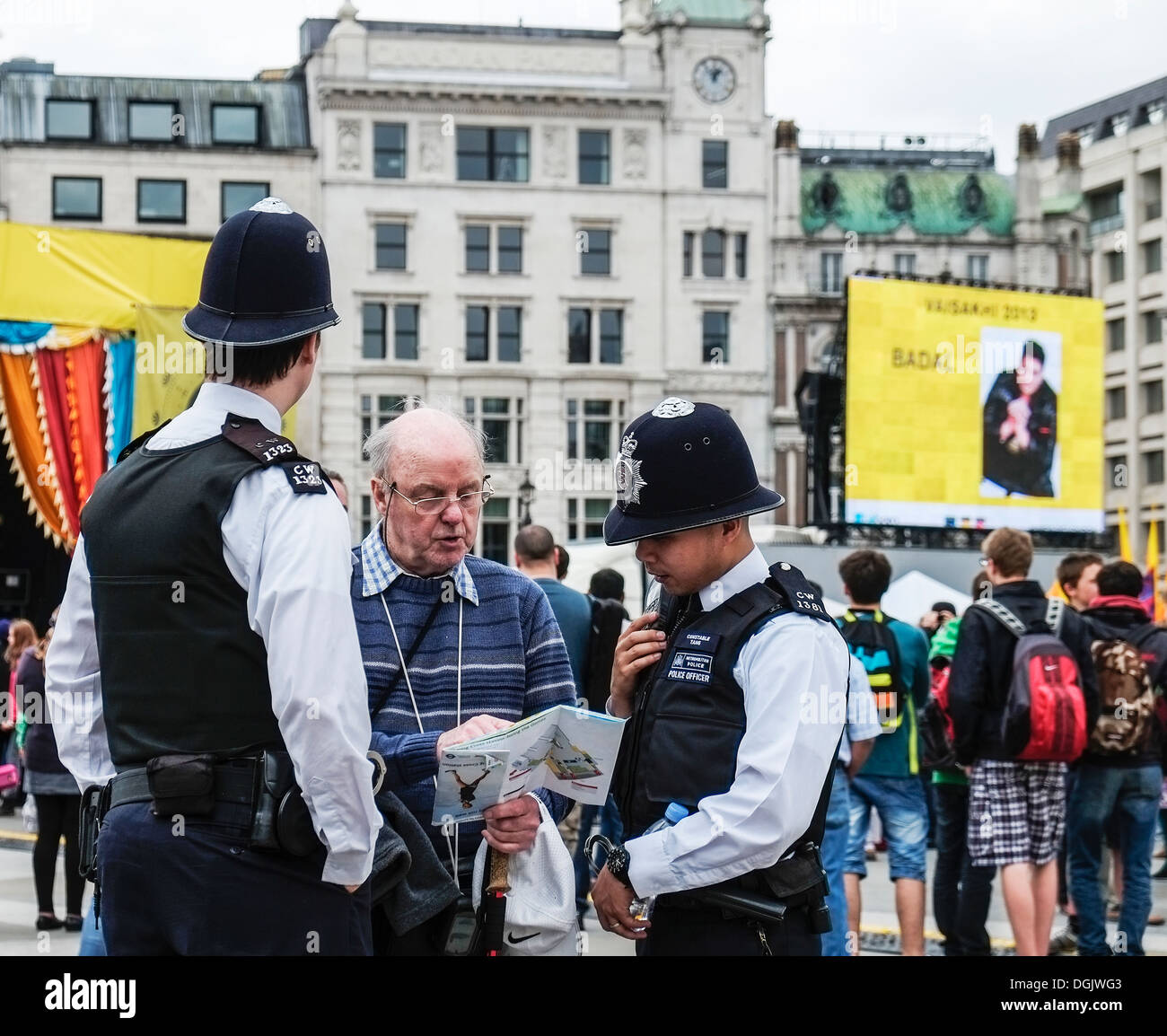 Two Metropolitan Police officers helping a tourist. Stock Photo