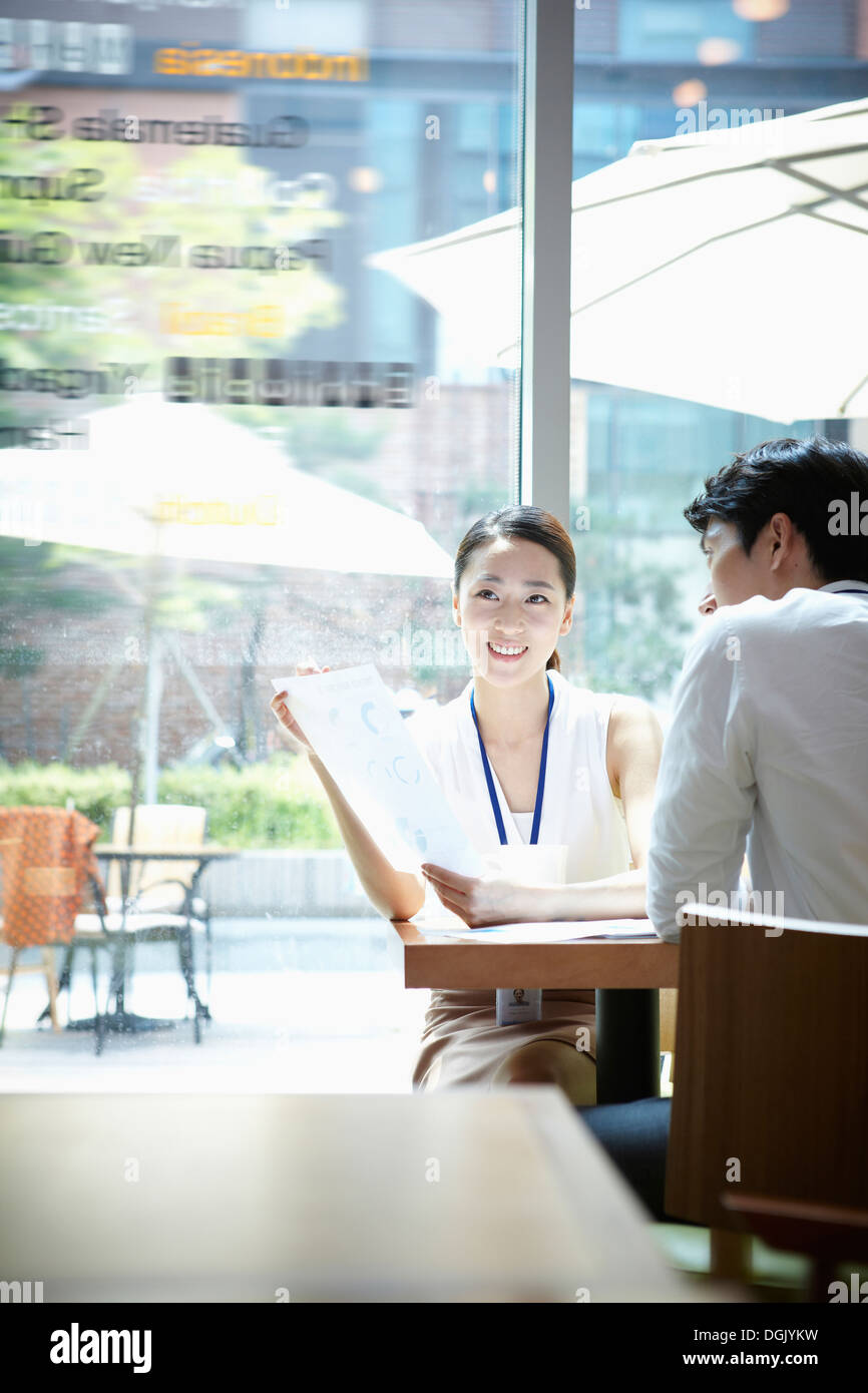 Man woman sitting table face hi-res stock photography and images - Alamy