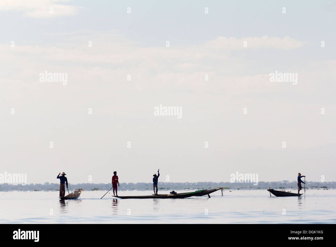 Silhouetted fishing boats in a line on Lake Inle in Myanmar. Stock Photo