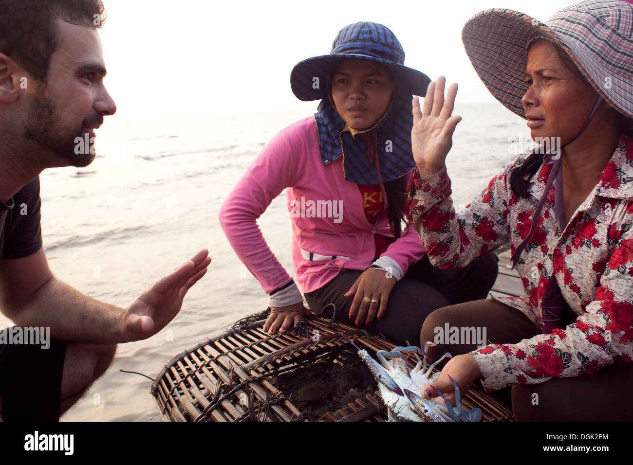 Women sell crabs at the crab market in the resort town of Kep, Cambodia. Photos © Dennis Drenner 2013. Stock Photo