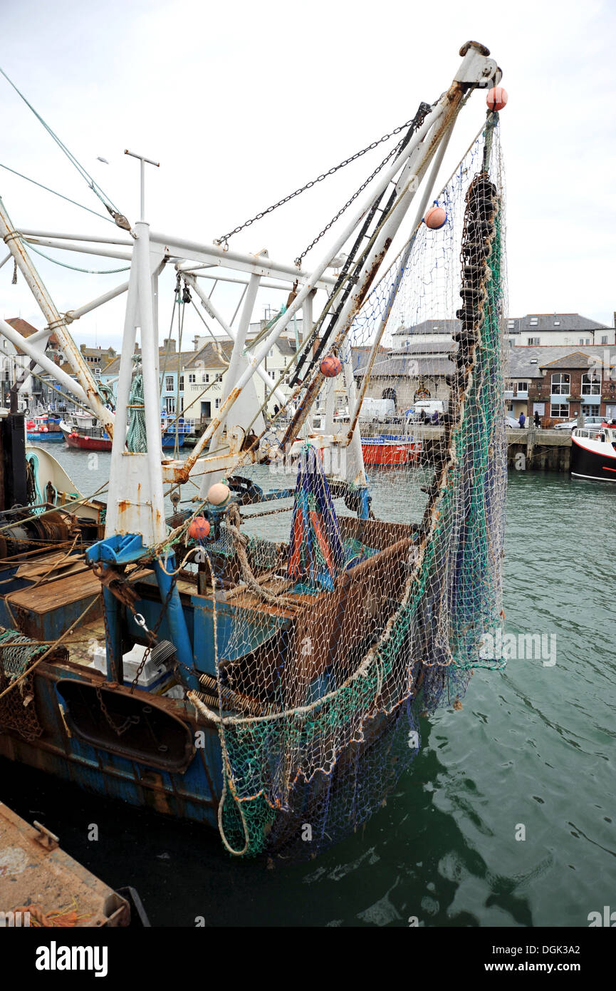 Fishing nets on the back of a trawler in West Bay harbour, Dorset Stock  Photo - Alamy