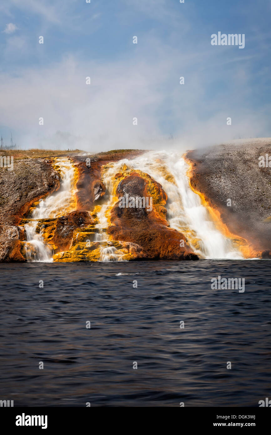 Overflow from Excelsior Geyser runs into the Yellowstone River, Midway Geyser Basin, Yellowstone National Park, Wyoming Stock Photo