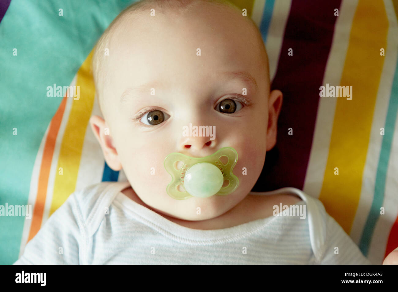 Portrait of baby boy sucking pacifier Stock Photo