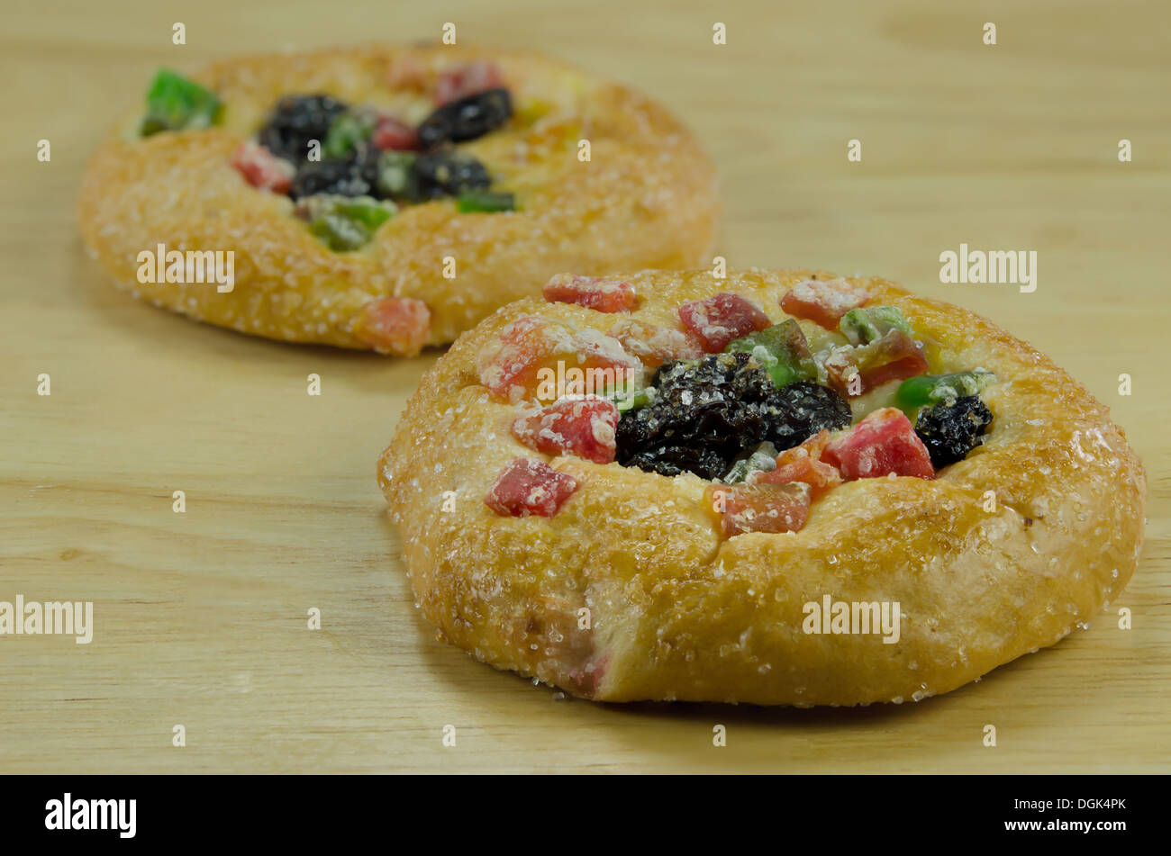close up bread with sugar , raisin and dried fruits on wooden board Stock Photo