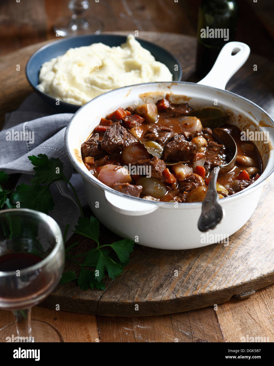 Beef daube in casserole dish with bowl of mashed potatoes Stock Photo