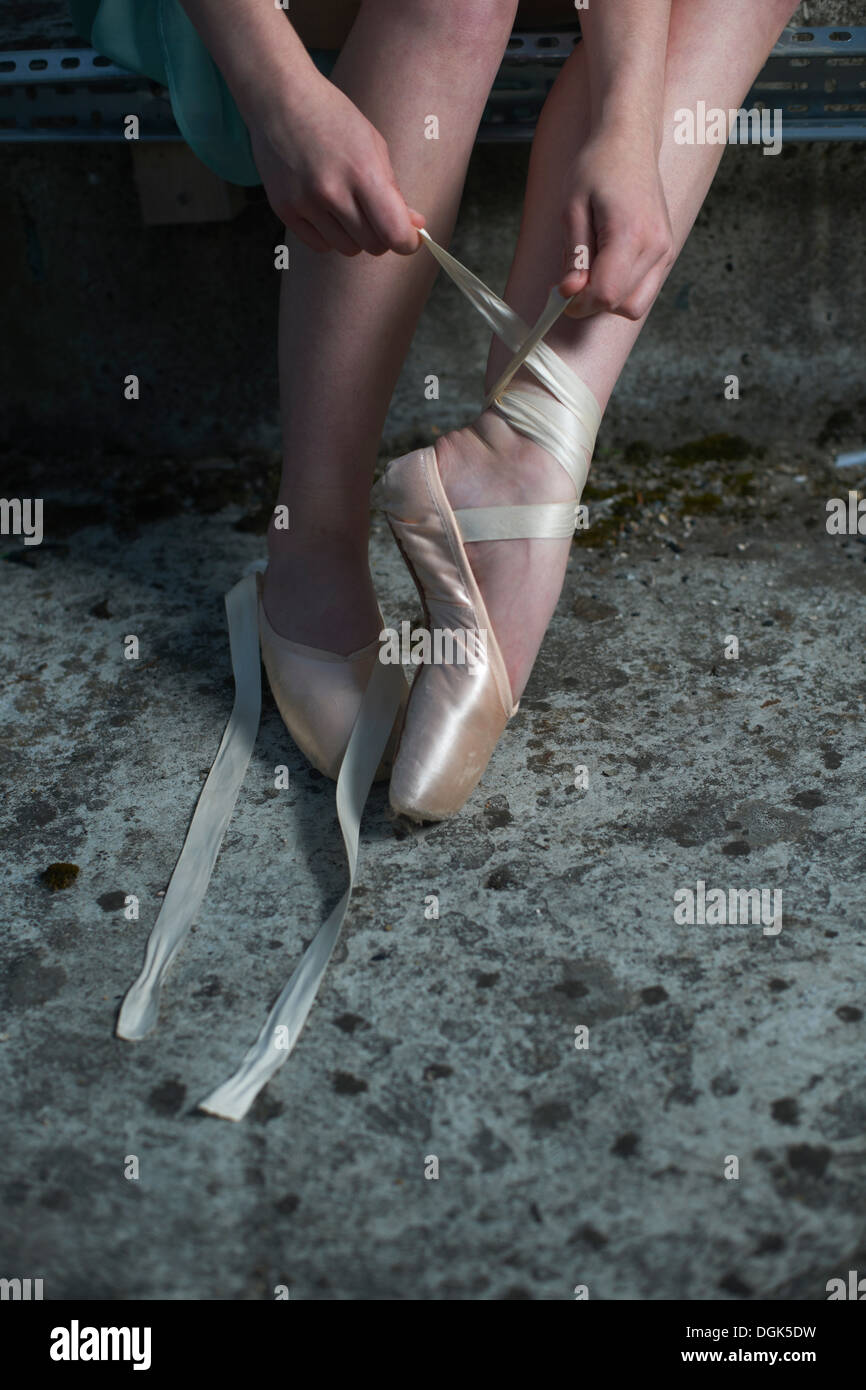 Ballet dancer tying ribbon on ballet shoe Stock Photo Alamy