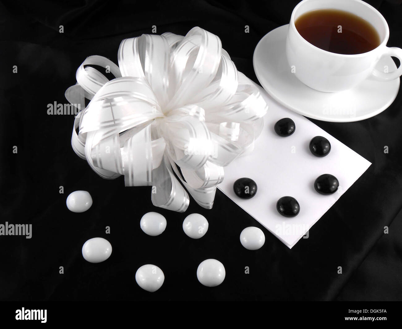 hot cup of tea with gift bow ribbon and stones Stock Photo