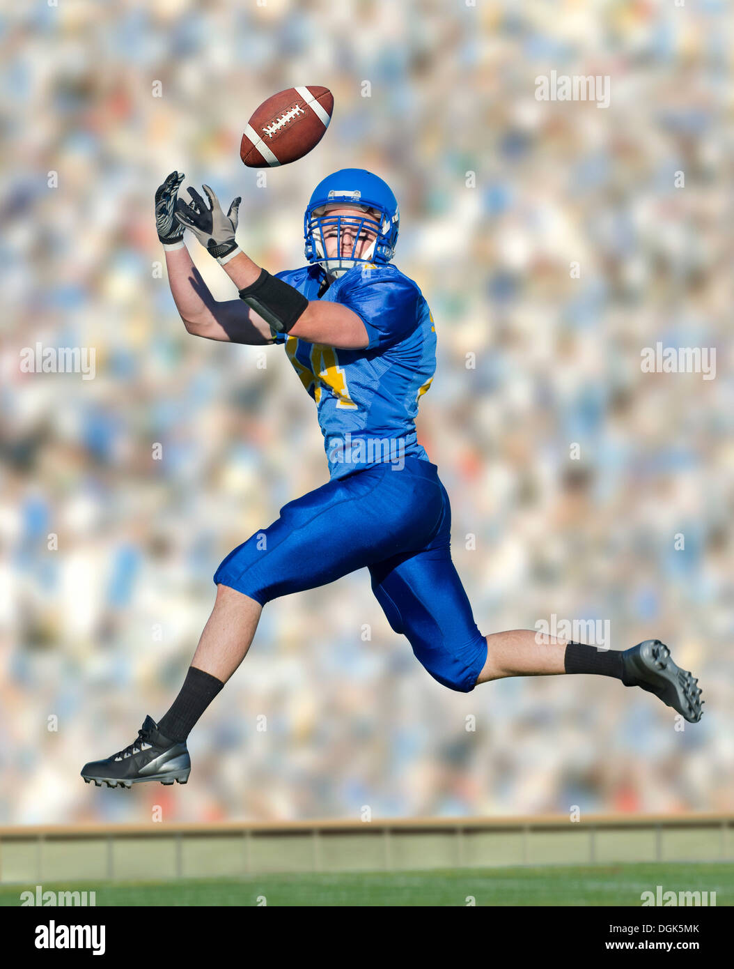 American footballer catching ball Stock Photo - Alamy