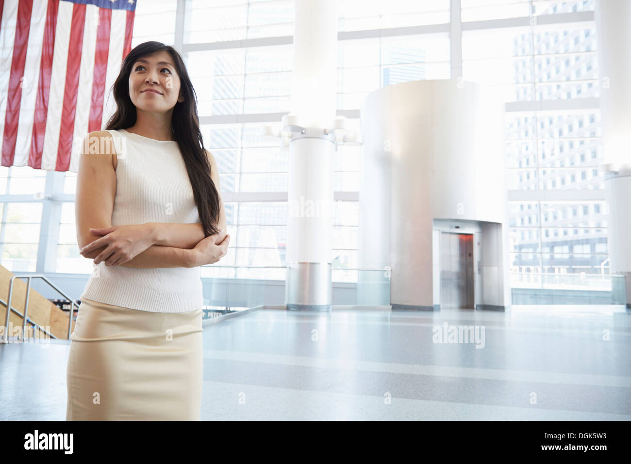 Businesswoman standing in Staten Island Ferry terminal Stock Photo