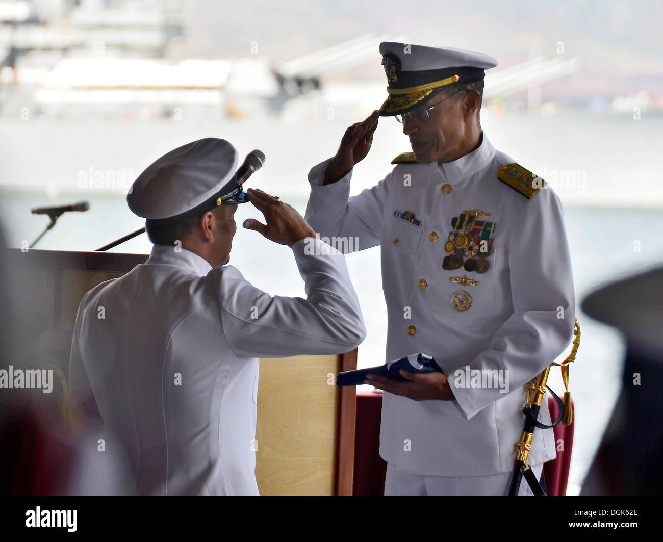 Adm. Cecil Haney, commander of U.S. Pacific Fleet (PACFLT) accepts his pennant from U.S. Pacific Fleet Master Chief Marco Ramirez during a change of command ceremony on the Pearl Harbor waterfront. During the ceremony, Adm. Harry B. Harris Jr. assumed com Stock Photo