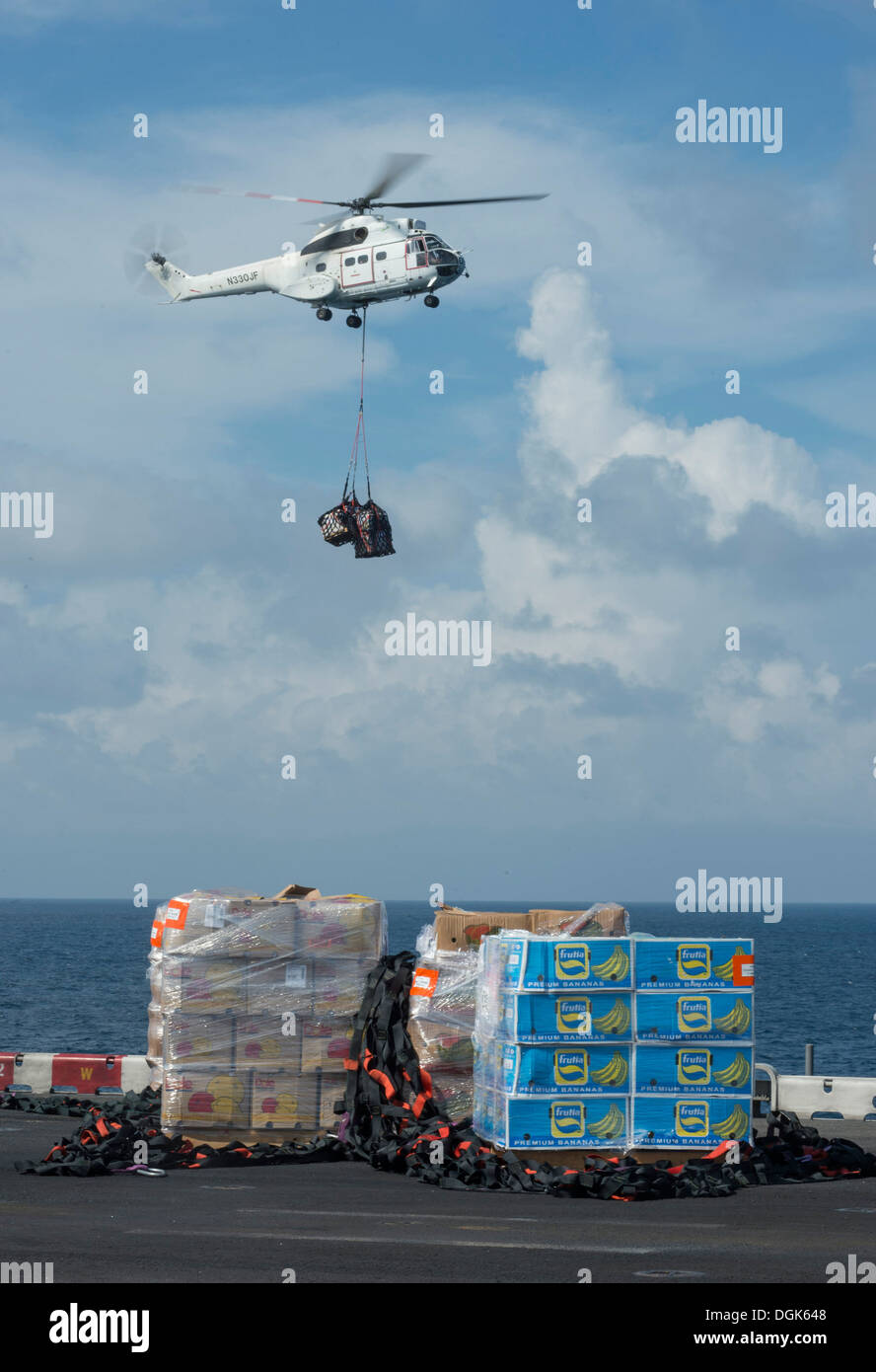 An SA-330 Puma helicopter prepares to drop off cargo aboard the amphibious assault ship USS Boxer (LHD 4). Boxer is the flagship for the Boxer Amphibious Ready Group and, with the embarked 13th Marine Expeditionary Unit, is deployed in support of maritime Stock Photo