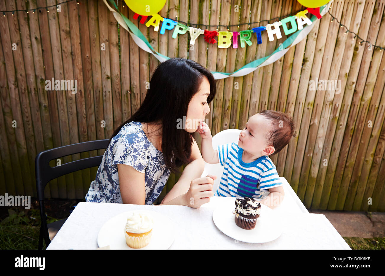 Baby boy putting fingers in mother's mouth Stock Photo Alamy