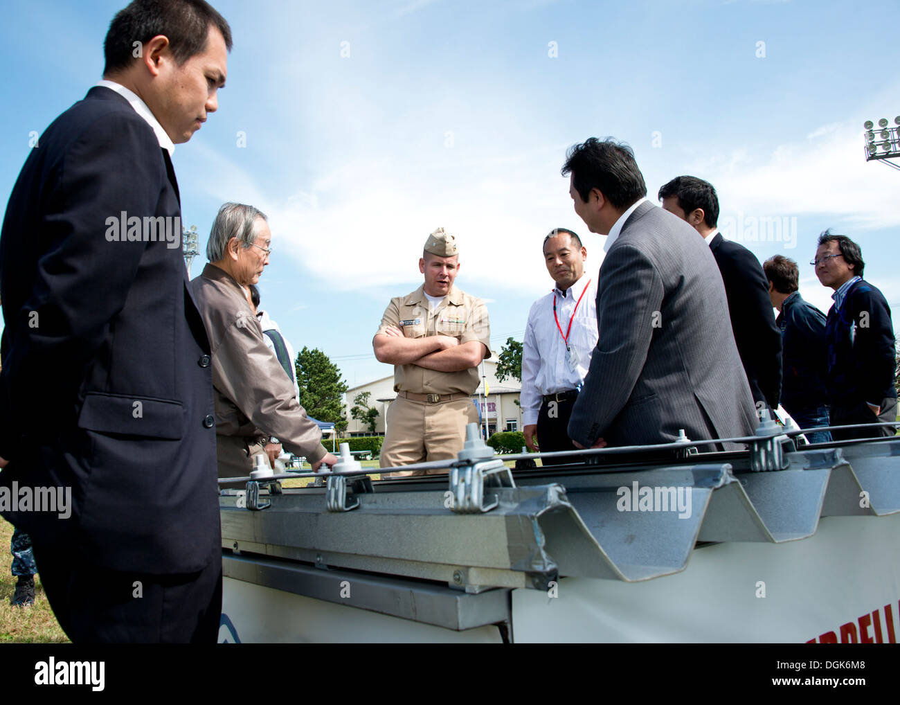 Naval Air Facility (NAF) Atsugi Public Works Officer Cmdr. Jeff Sherwood speaks with local Japanese officials about the base's energy efficiency policies during the annual energy fair at Taylor Field. The event is held to promote the smart usage of energy Stock Photo