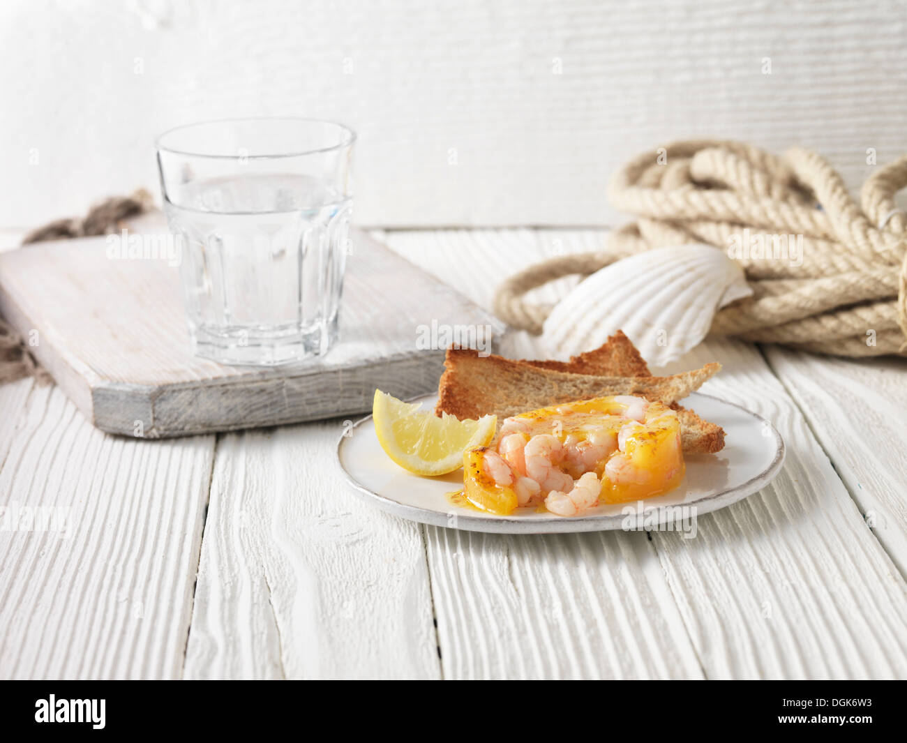 Potted prawns with wholemeal toast and lemon Stock Photo