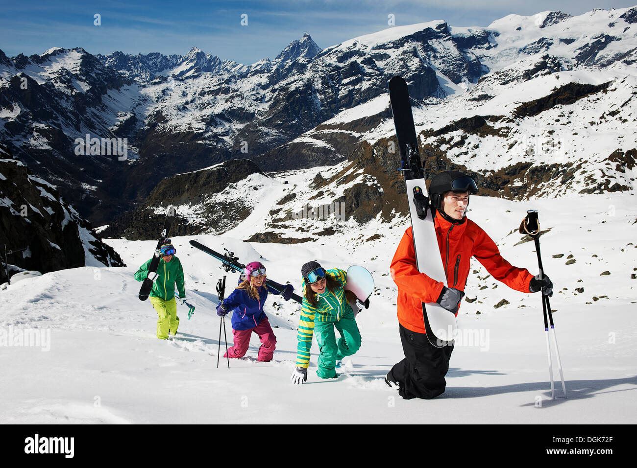 Group of skiers climbing mountain with ski equipment Stock Photo