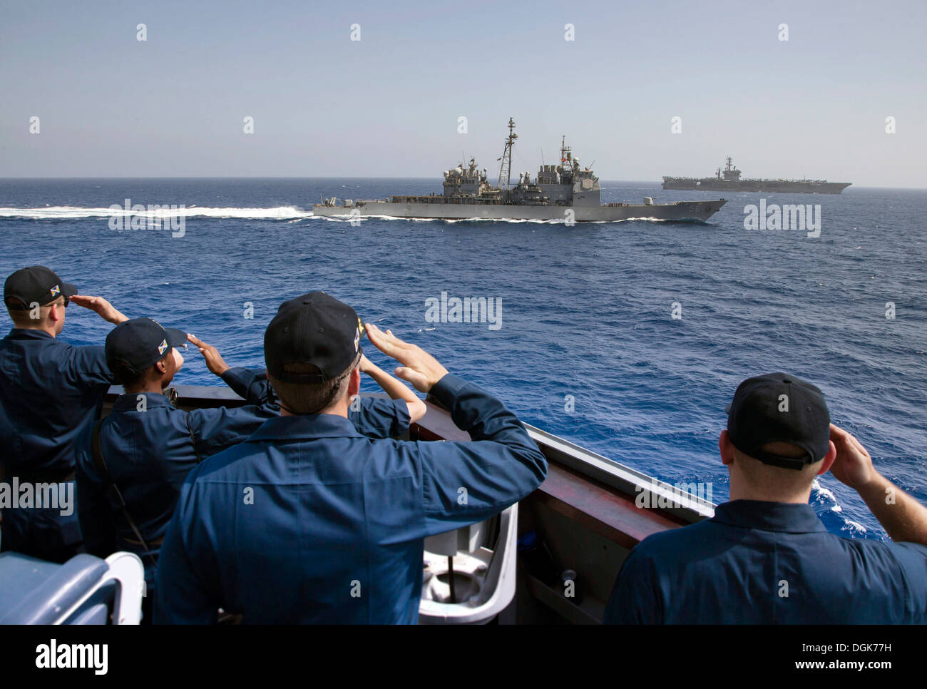 Cmdr. Wilson Marks, commanding officer of the guided-missile destroyer USS Mason (DDG 87), bottom center, renders passing honors to the guided-missile cruiser USS San Jacinto (CG 56). The aircraft carrier USS Nimitz (CVN 68), top right, guards the formati Stock Photo
