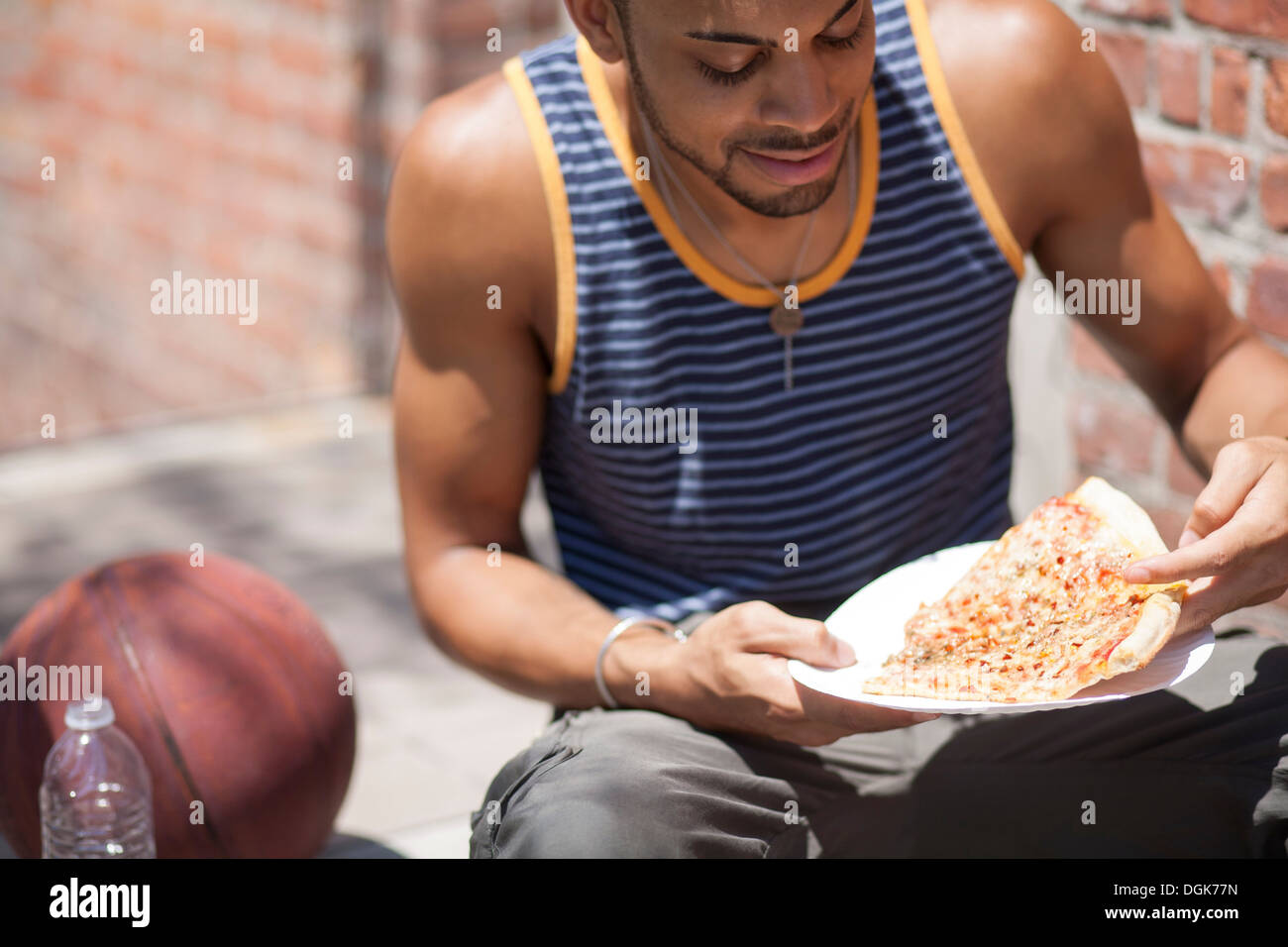 Basketball player with a slice of pizza Stock Photo Alamy