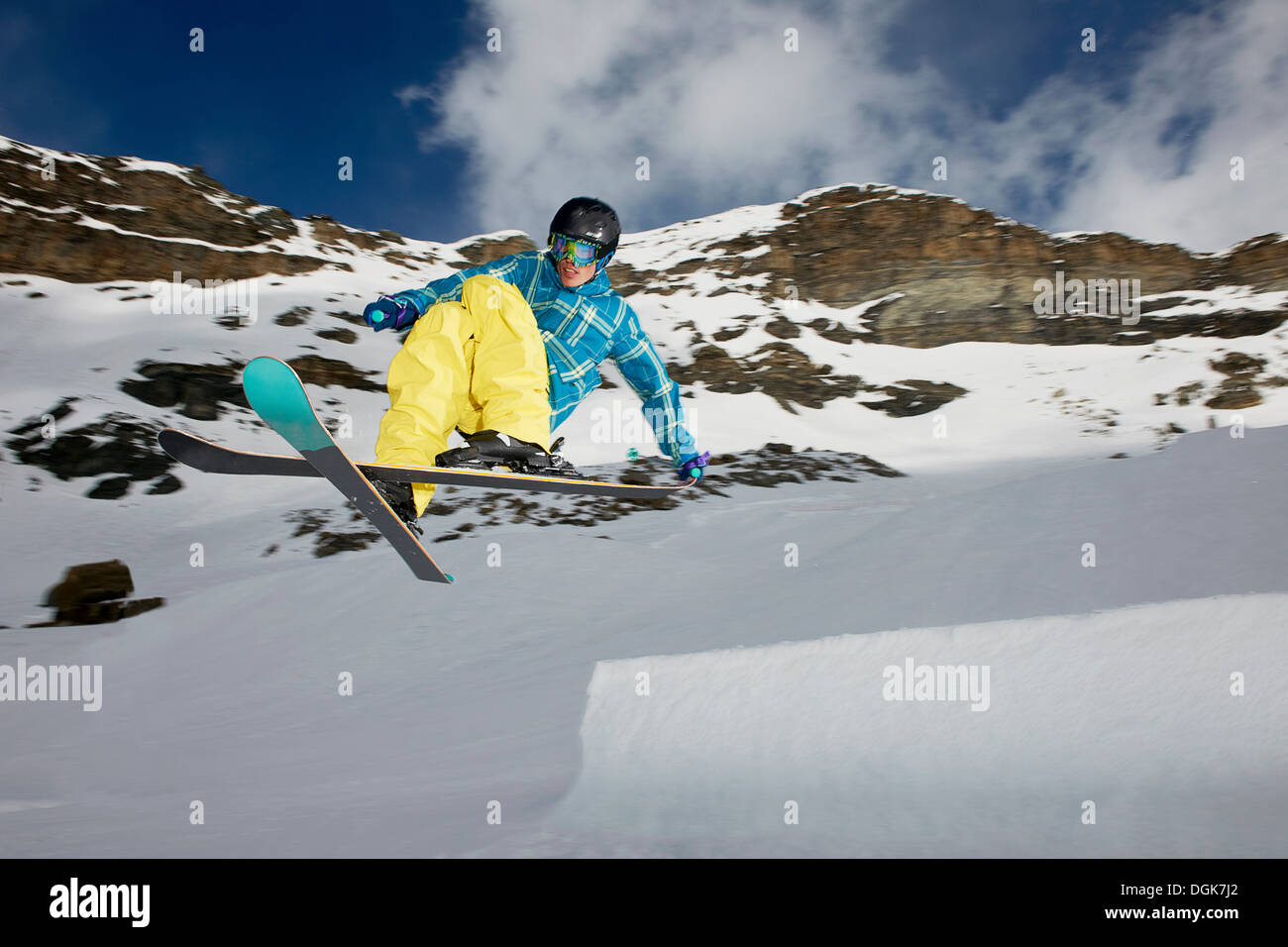 Male skier mid air with crossed skis Stock Photo