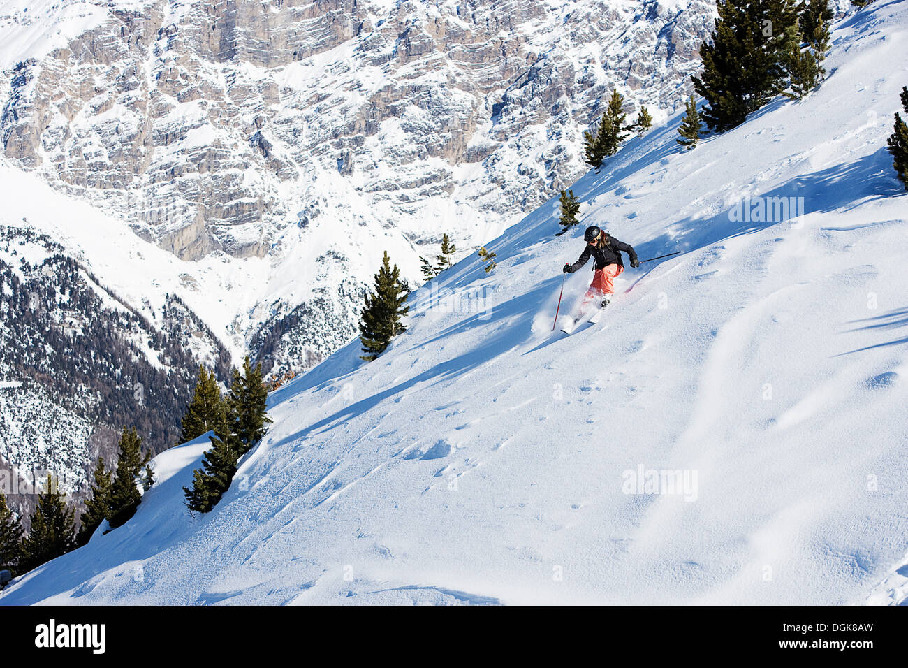 Female skiing down mountain Stock Photo