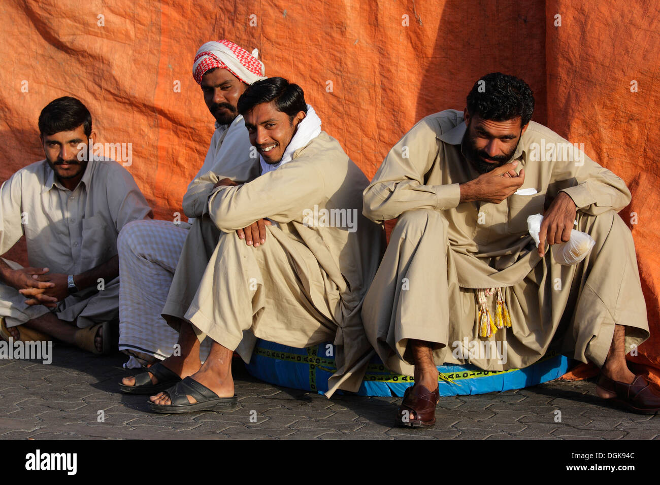 Dock workers taking a break on Dubai Creek. Stock Photo