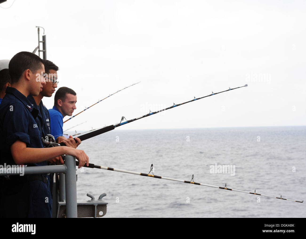 Sailors fish from the fantail of the aircraft carrier USS Ronald Stock