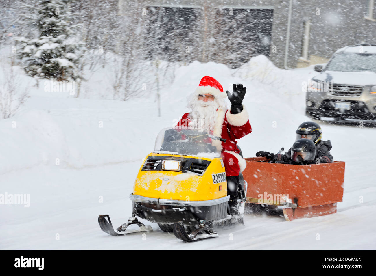 Santa Claus takes the children for a snowmachine ride Greater Sudbury Ontario Canada Stock Photo