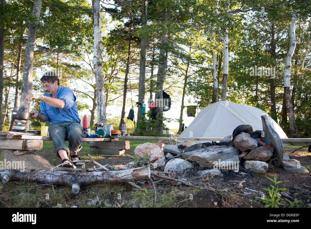 Mature man cooking on campsite, Bath, Maine, USA Stock Photo Alamy