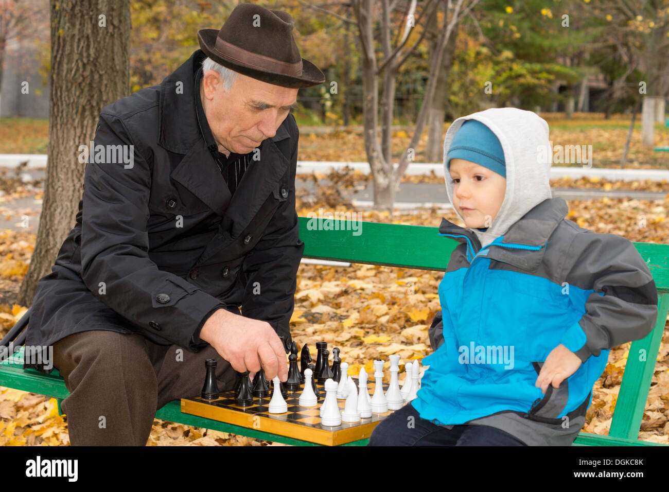 Smiling grandfather having idea about next chess move Stock Photo by  ©Dmyrto_Z 165212578