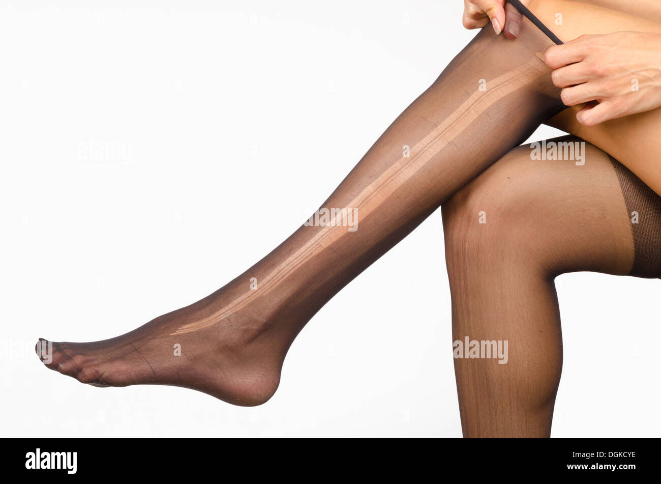 Female legs with a ripped pantyhose on Stock Photo - Alamy