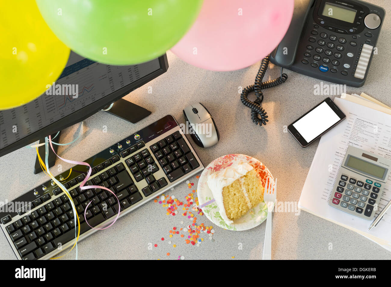 Studio shot of office workspace with cake and balloons Stock Photo - Alamy