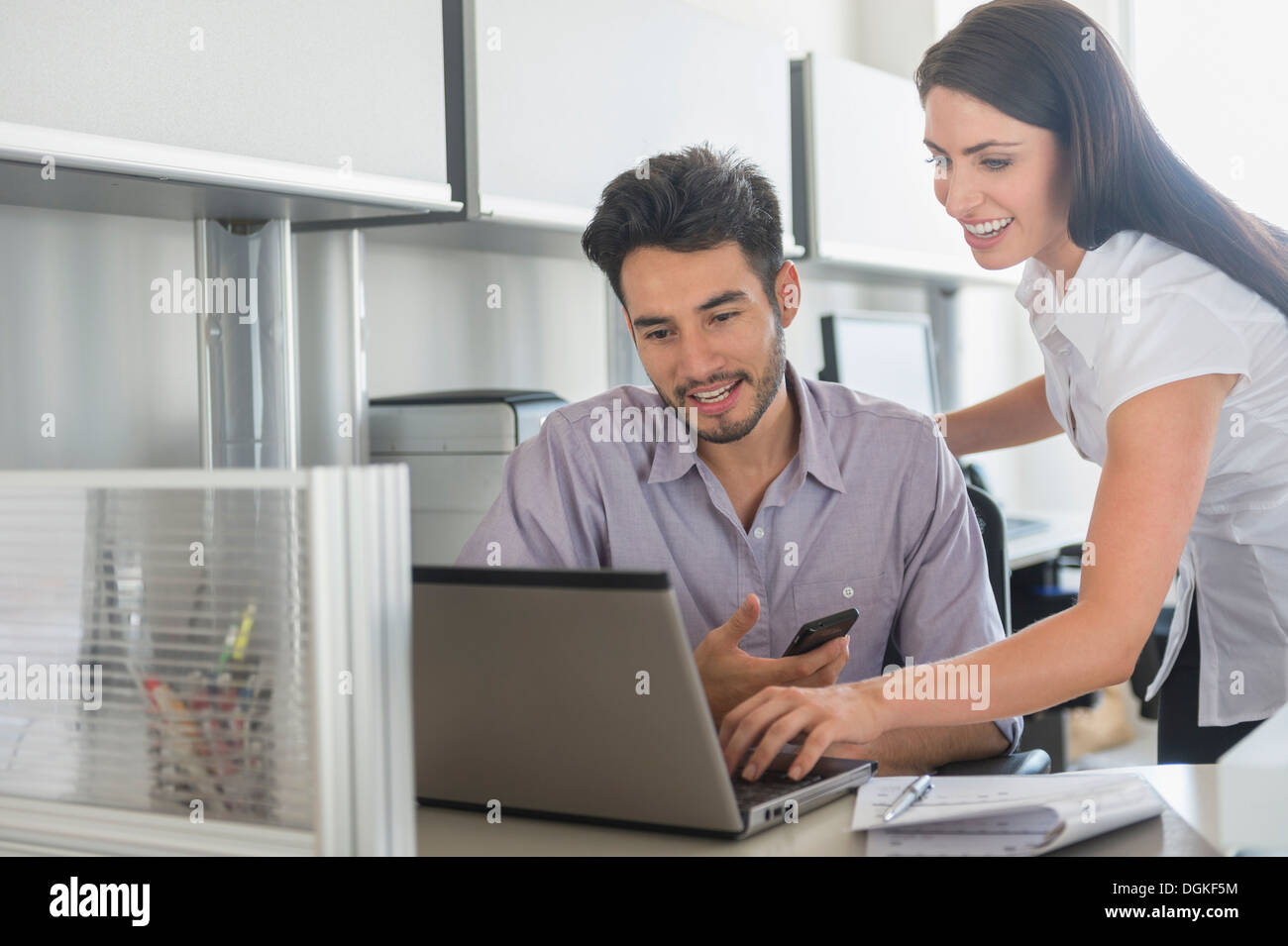 Business man and woman at work in office Stock Photo - Alamy