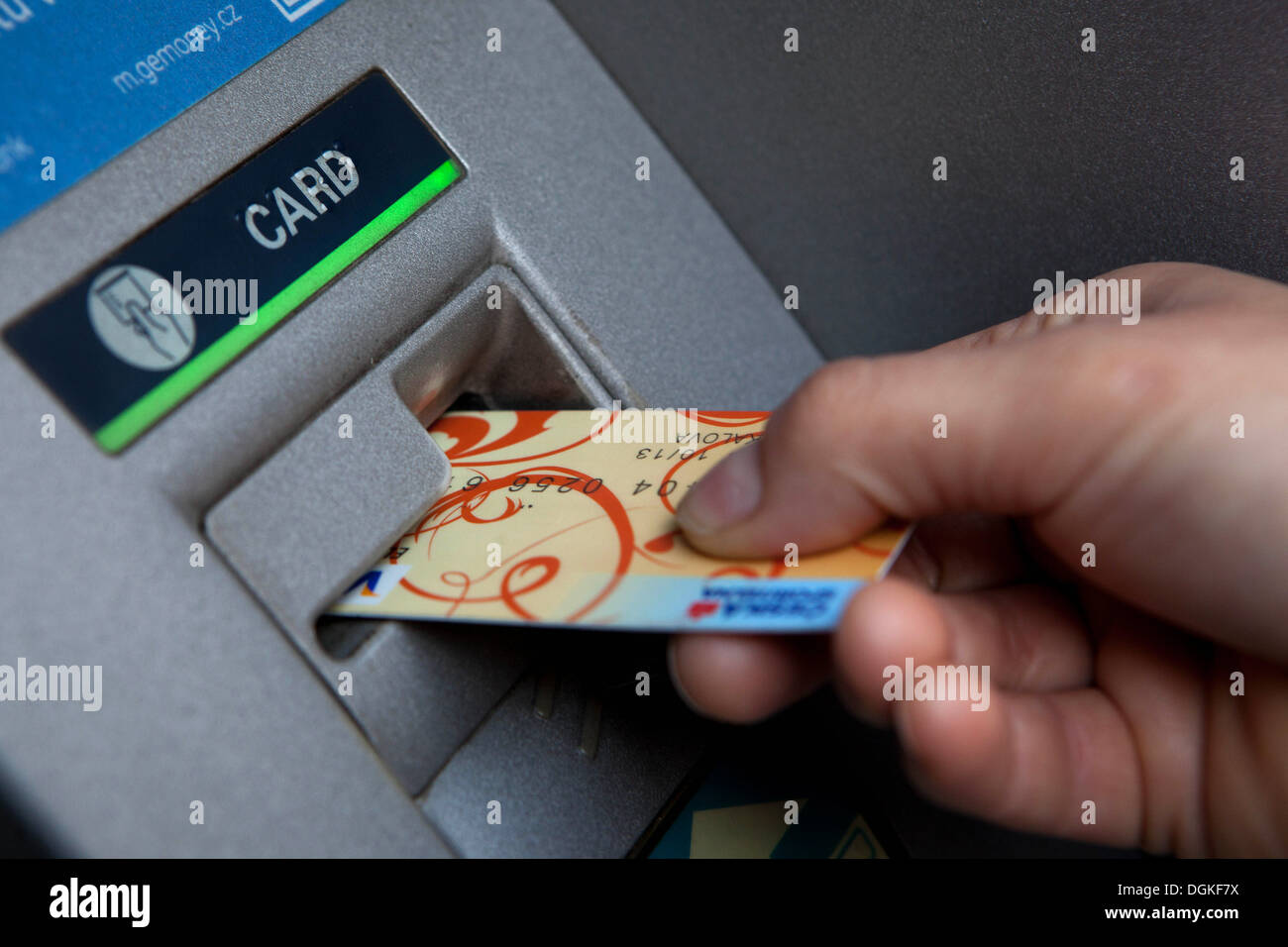 Insert credit card into an ATM machine Stock Photo