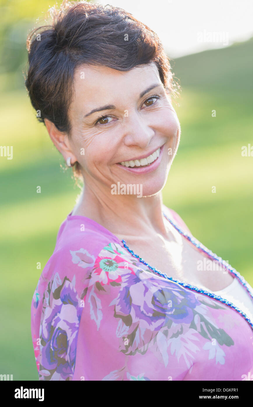 Portrait of mature woman smiling outdoors Stock Photo