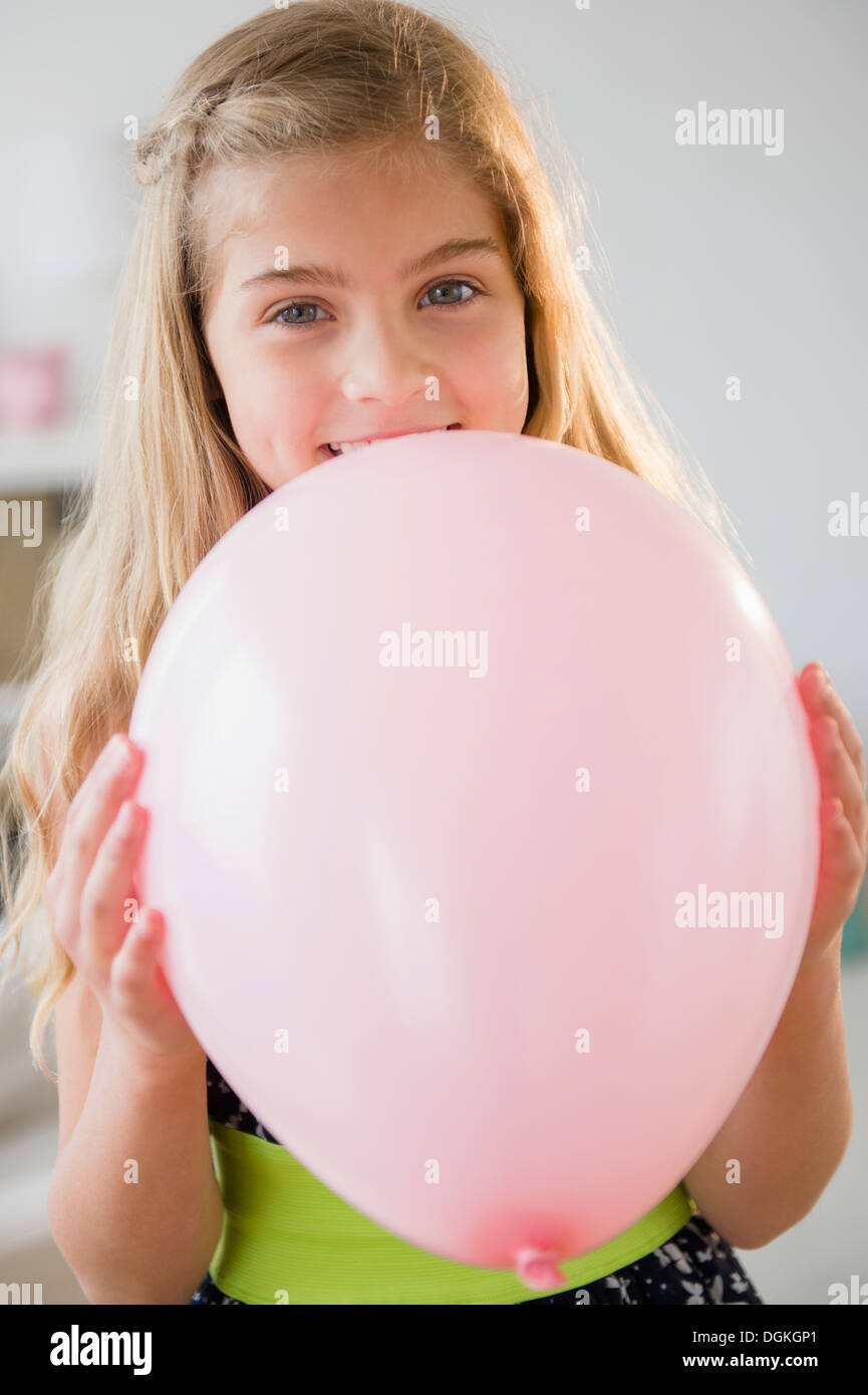 Girl (8-9) with pink balloon Stock Photo
