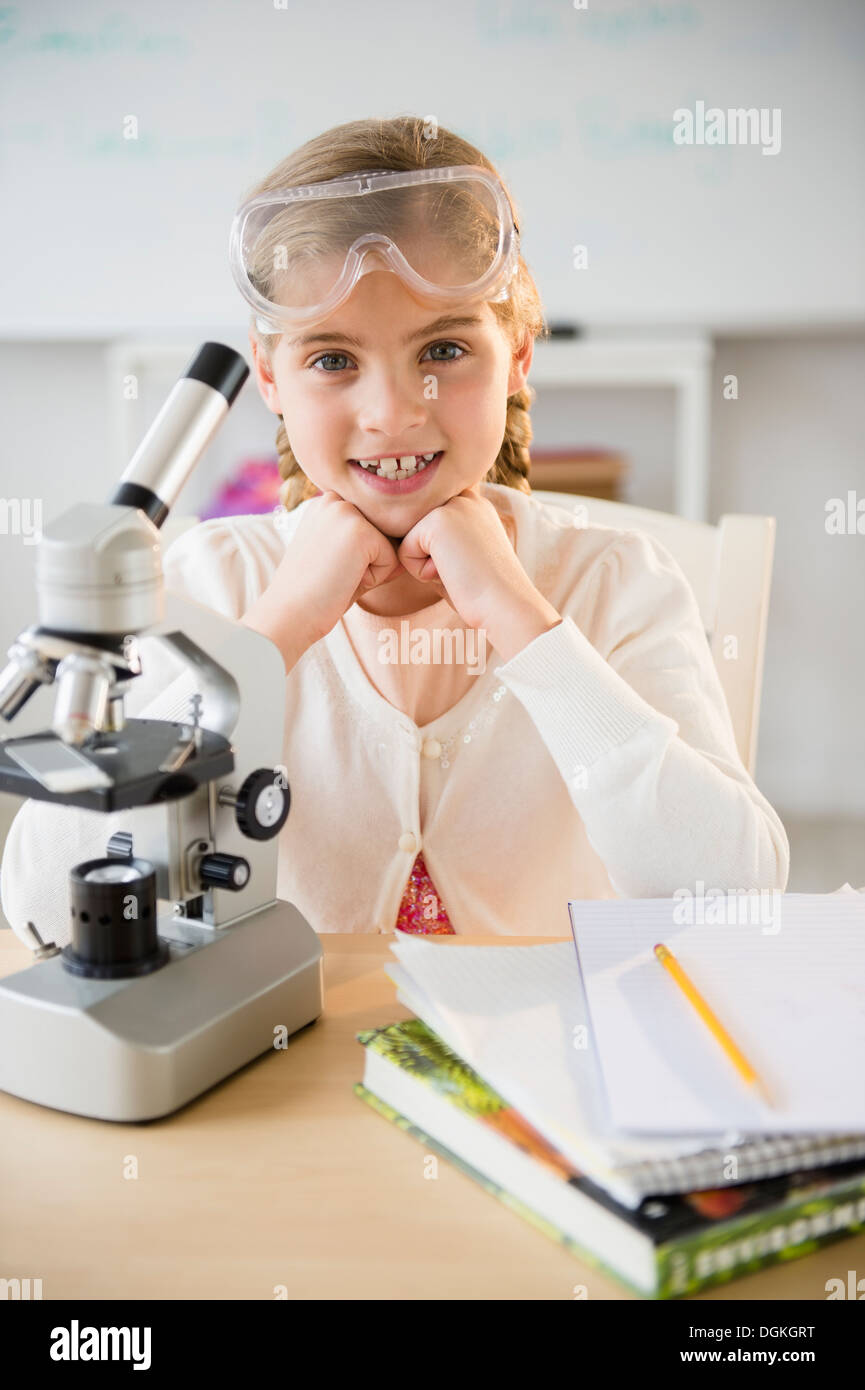 Portrait of girl (8-9) with microscope Stock Photo