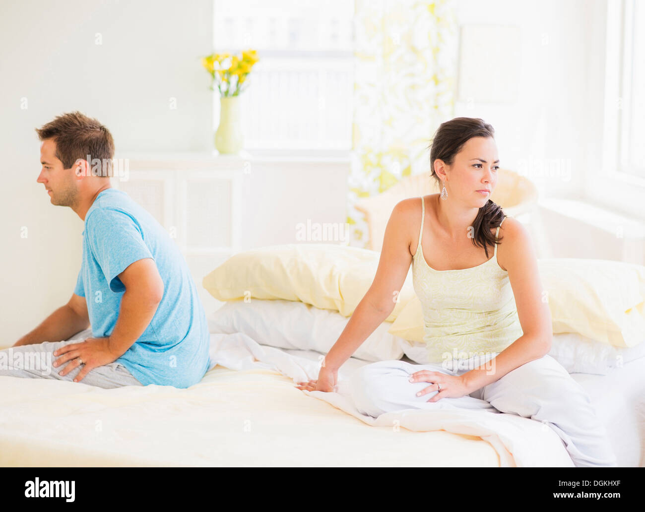 Sad woman sitting on bed Stock Photo